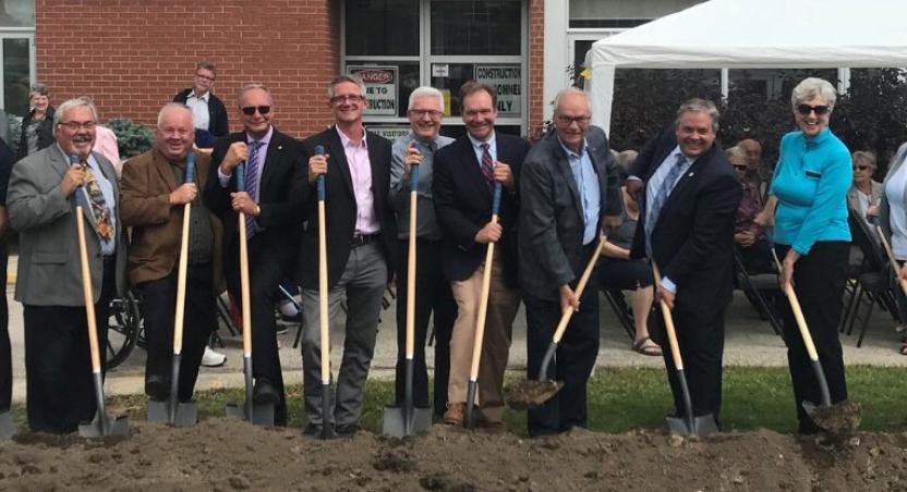 people with shovels in the ground