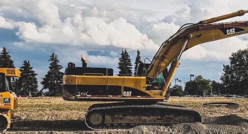 bulldozer and excavator working on road