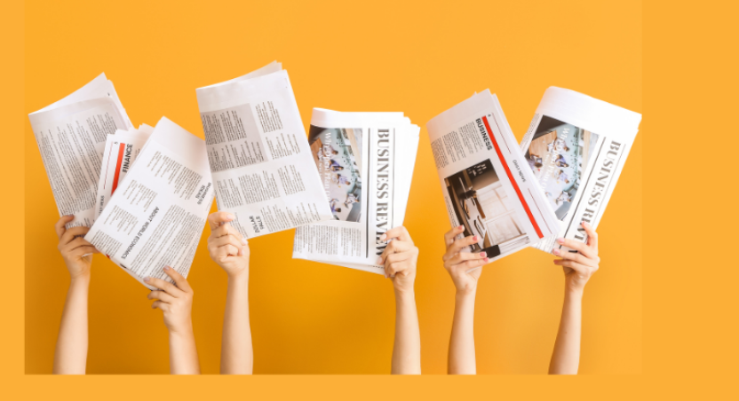 Hands holding up newspapers