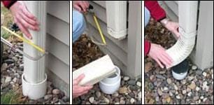 A pair of hands disconnecting a downspout