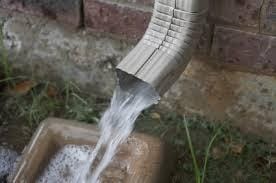 Downspout with water pouring out